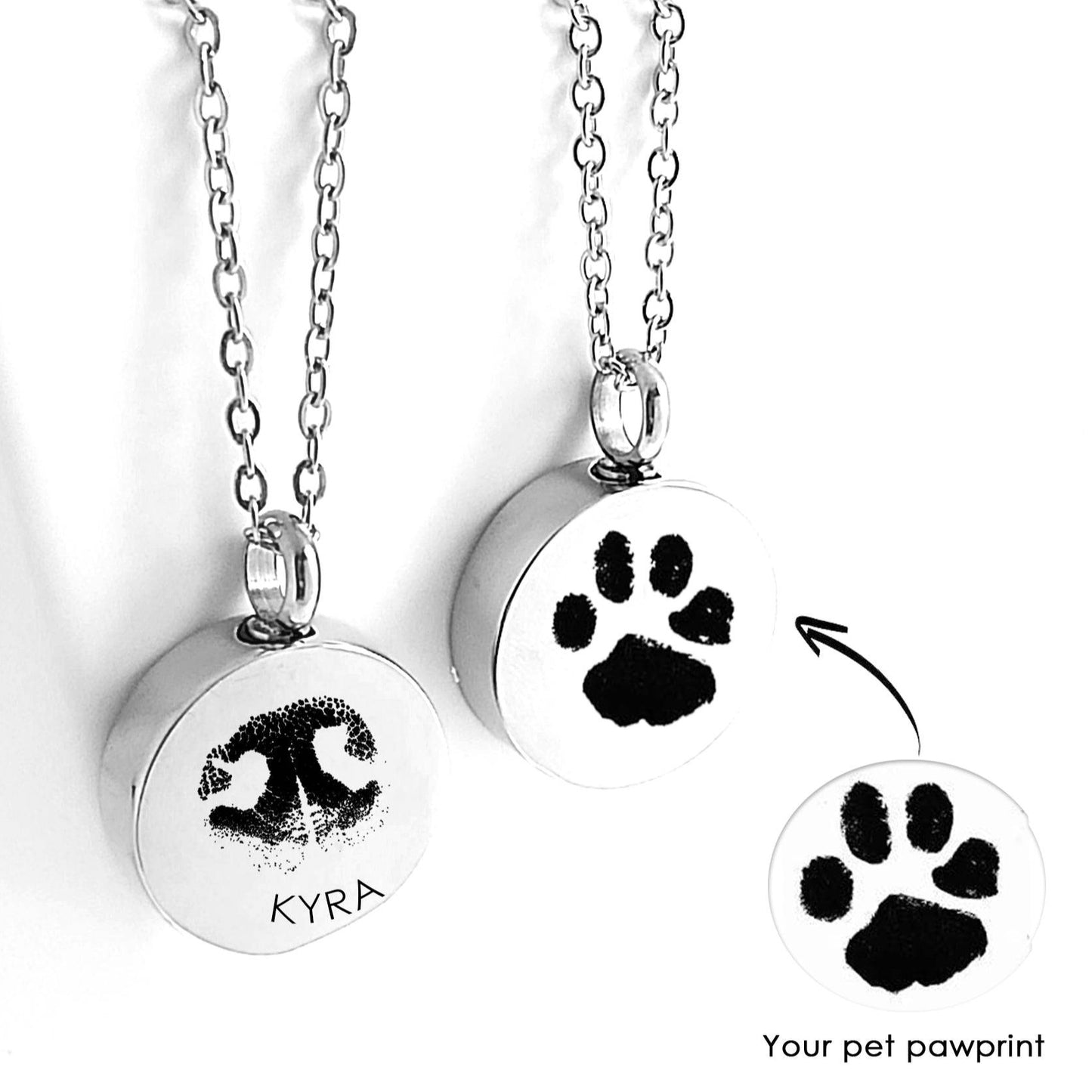 Two silver urn necklaces with paw prints and the name 'Kyra' on a white background