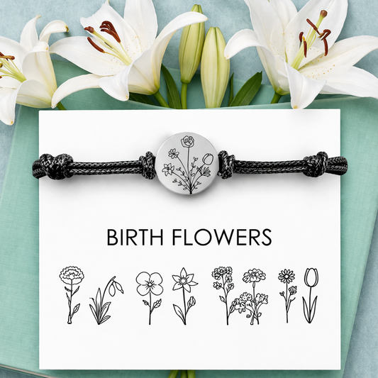 Personalized birth flower bracelet with engraved stainless steel charm on black cord, displayed on a minimalist white card labeled “Birth Flowers,” set against a soft mint green background with white lilies. Custom family birth flower bouquet engraving, meaningful jewelry gift for mom or grandma, delicate floral design, sentimental keepsake, Mother’s Day gift, custom engraved bracelet, botanical jewelry.