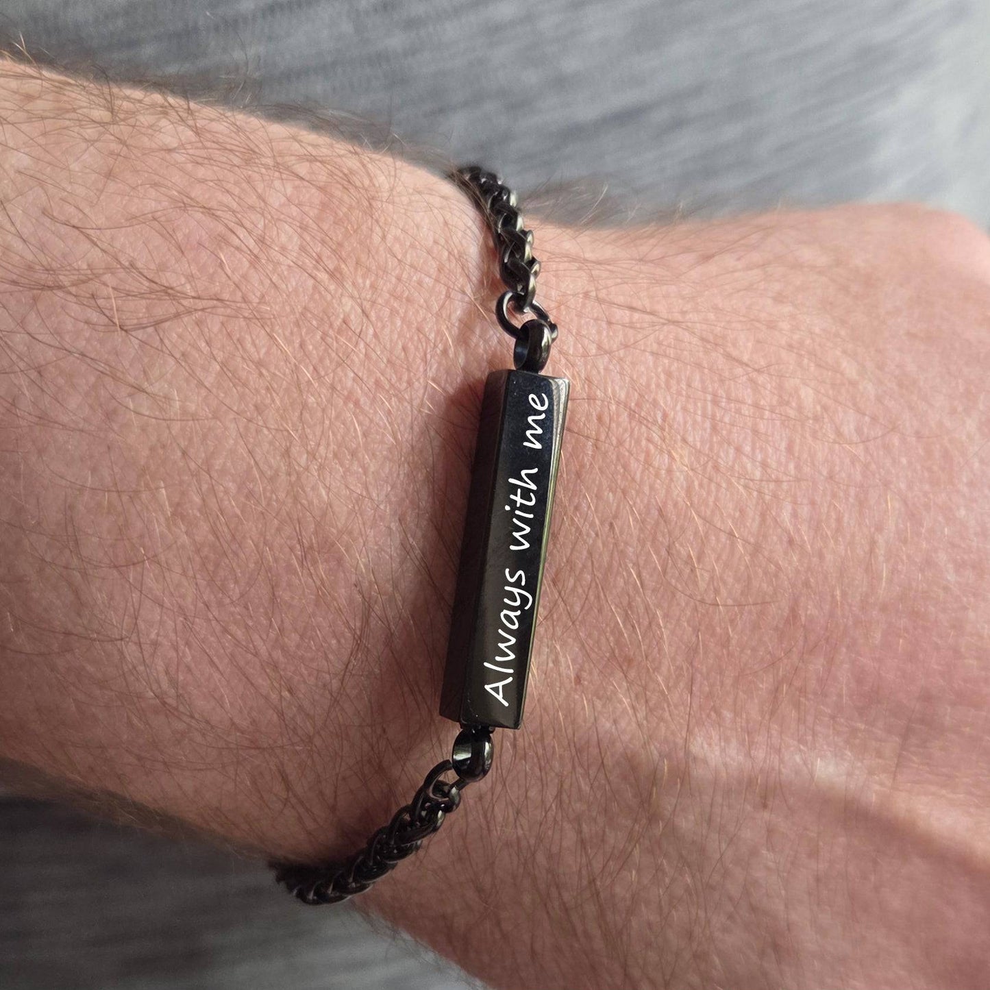 Bracelet with engraved message on wrist, labeled 'Waterproof'.