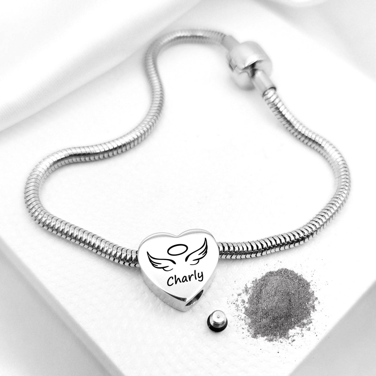 Silver bracelet with a heart-shaped charm and engraved text on a white background