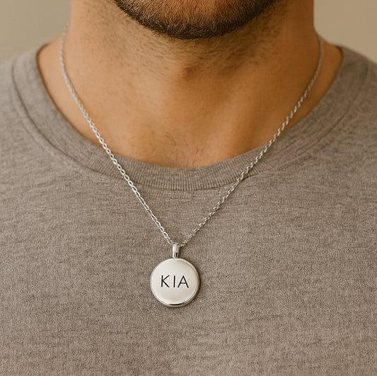 Locket engraved with initials and photos for her and him.
