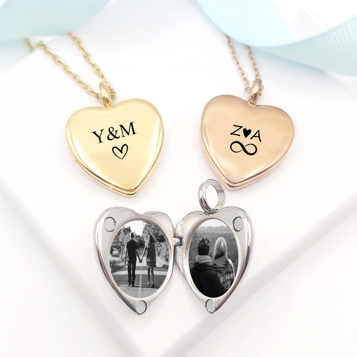 Heart-shaped photo locket with two heart pendants, one gold and one rose gold, on a white background.