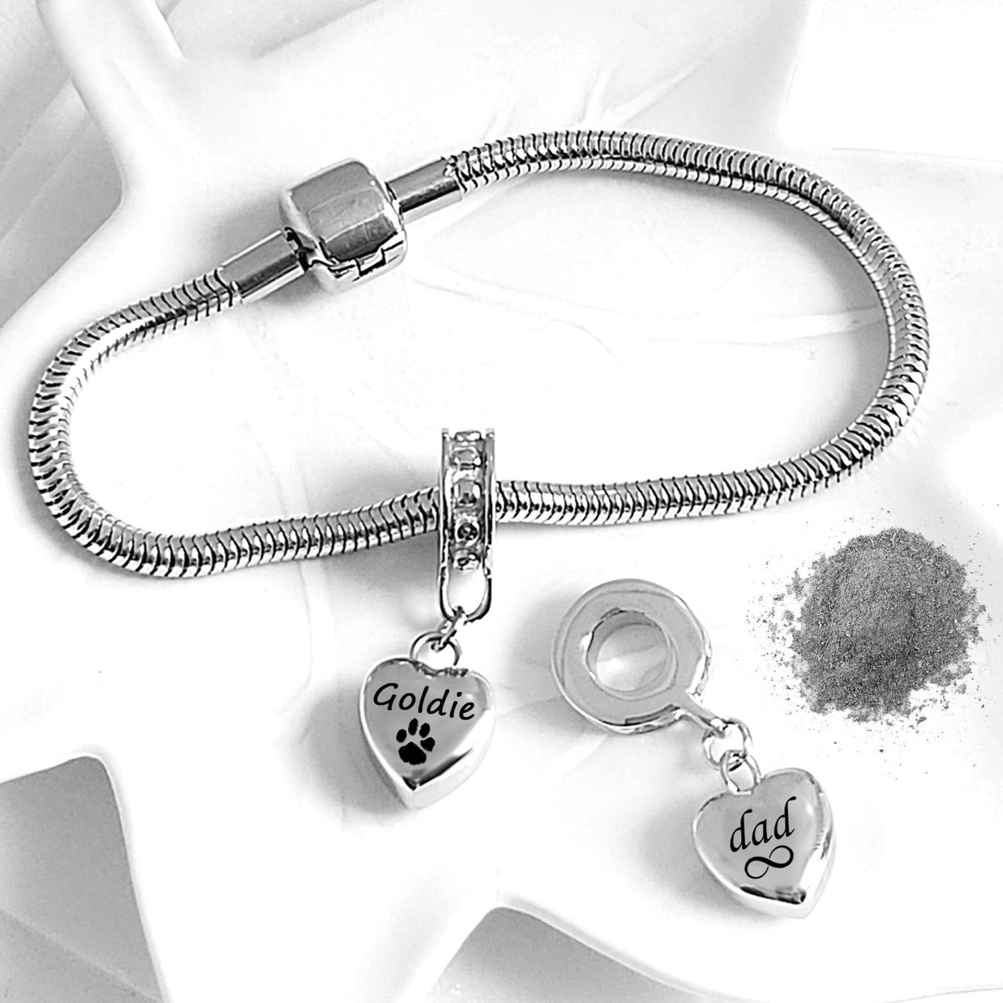 Silver bracelet with heart-shaped charms on a white background