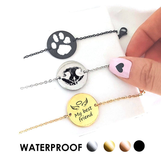 Bracelets with paw prints and engraved text on a white background