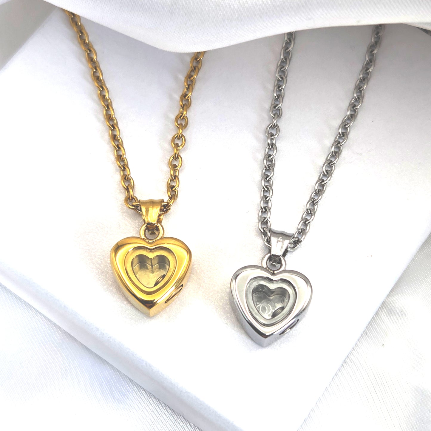 Custom thumbprint glass heart urn necklace for human ashes.