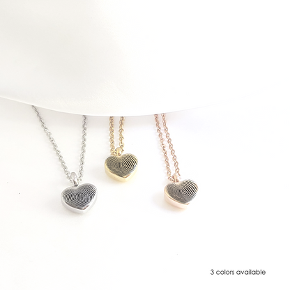 Personalized thumbprint heart urn necklace for human ashes.