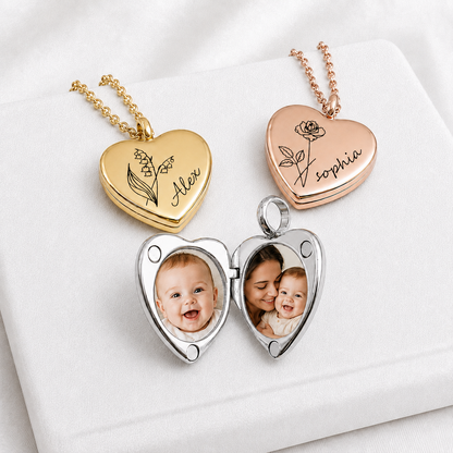 Three polished heart-shaped lockets displayed on white fabric: closed gold and rose-gold lockets engraved with birth flowers and the names Alex and Sophia, plus an open silver photo locket holding two family photographs.