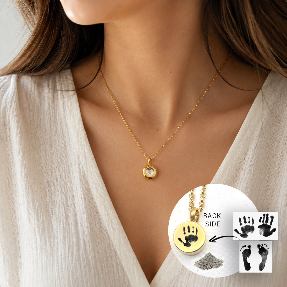 A woman wearing a small round gold necklace with a clear glass centre and delicate gold chain. A circular inset labelled “Back Side” shows the polished gold back engraved with a black child’s handprint. Reference images of two handprints and two footprints appear beside a small pile of ashes.