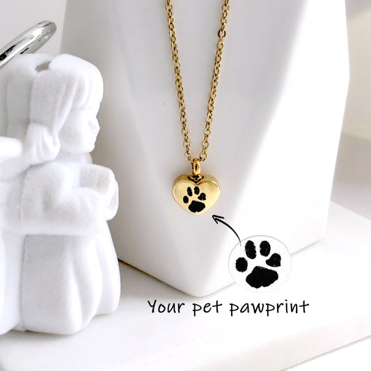Dog paw print cremation heart urn necklace for ashes.