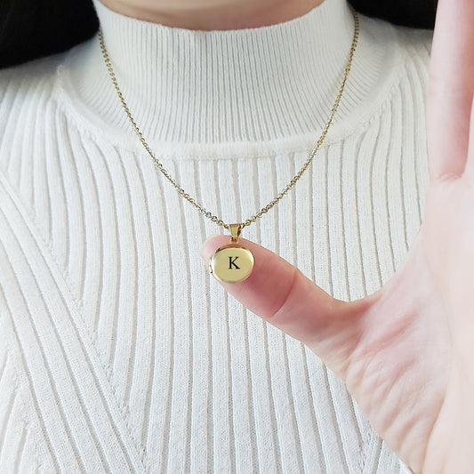 Tiny locket with engraving and photos.