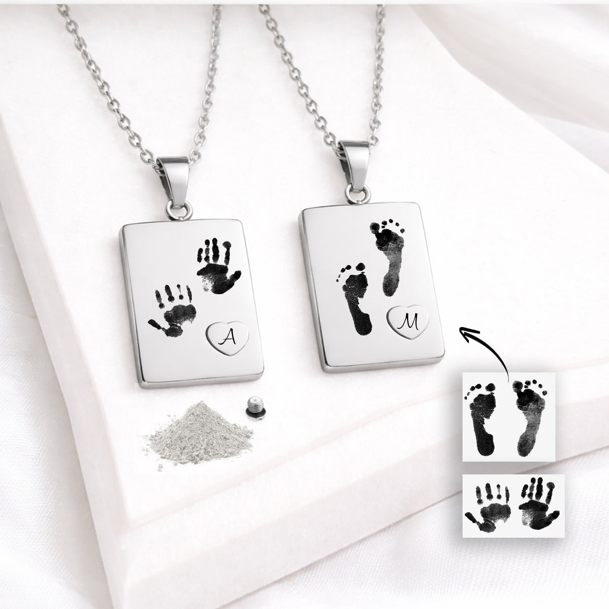 with two baby handprints and a raised heart containing the letter “A.” The other features two baby footprints and a heart with the letter “M.” Handprint and footprint reference images, ashes and a threaded screw are also visible.