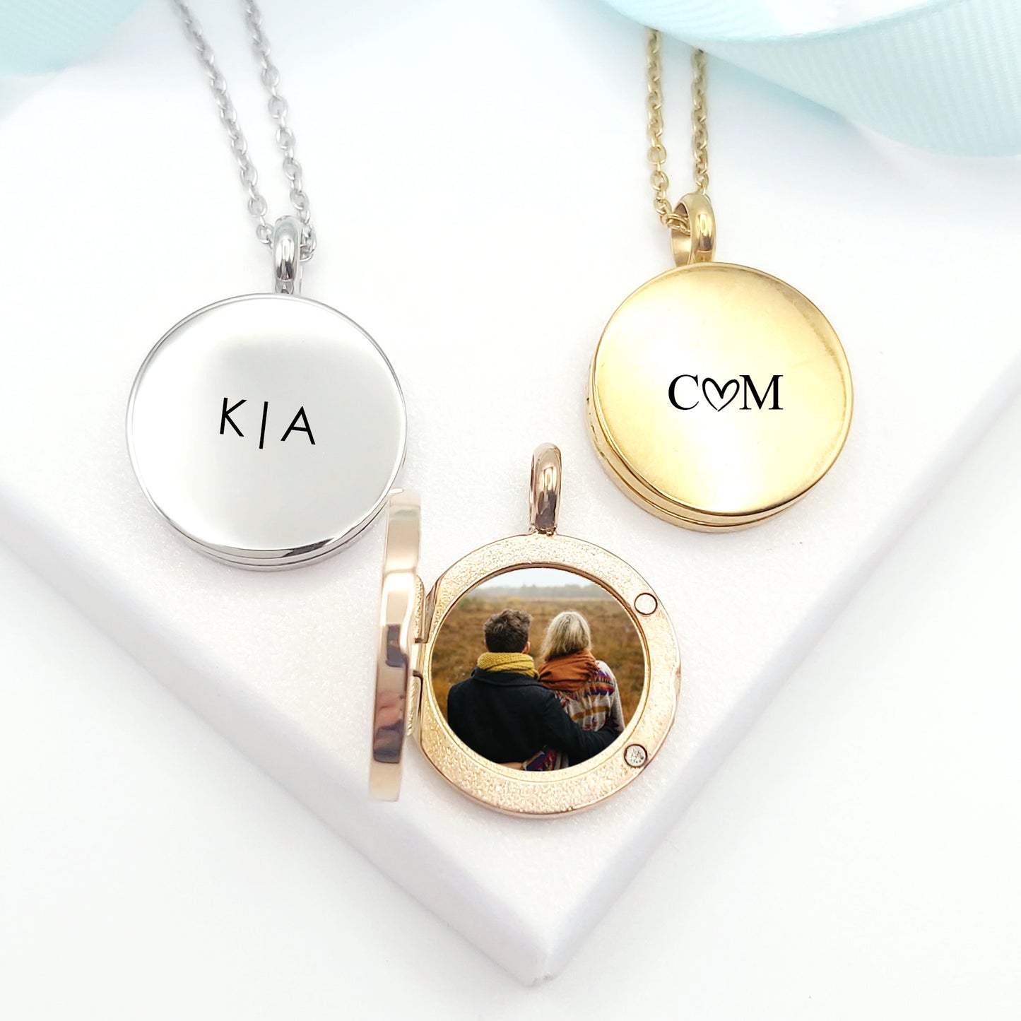Locket engraved with initials and photos for her and him.