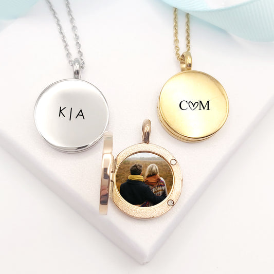 Anniversary locket personalized with names and initials for couples.