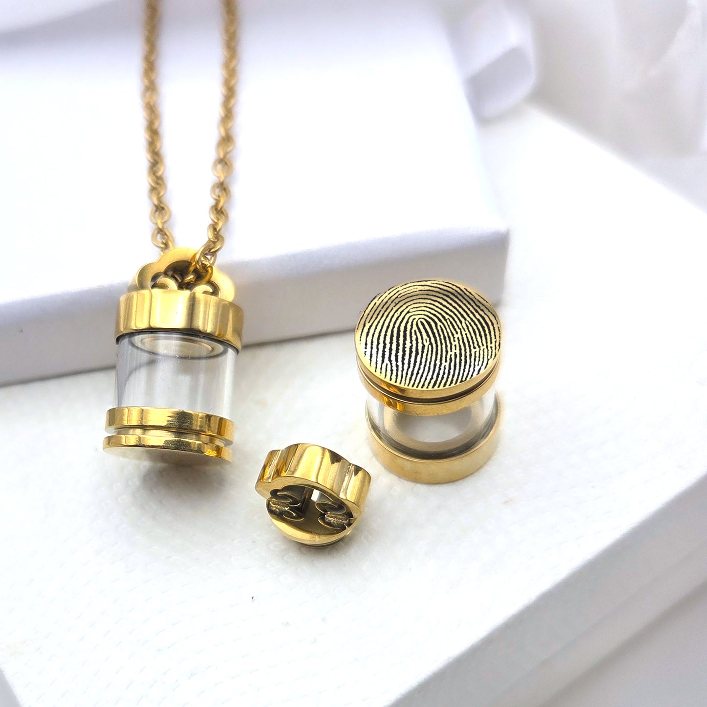 Memorial thumbprint glass urn necklace for human ashes.