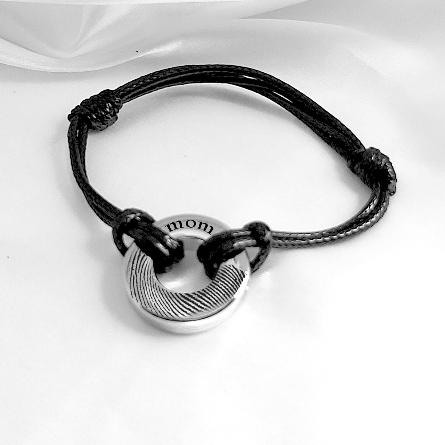 Custom thumbprint round urn bracelet for ashes.