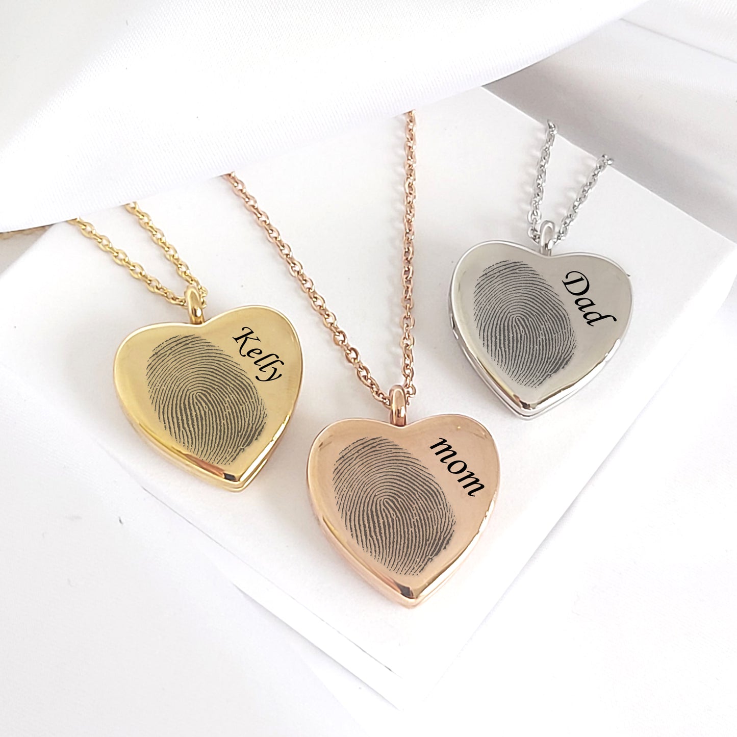 Memorial thumbprint heart locket with photos and engraving.
