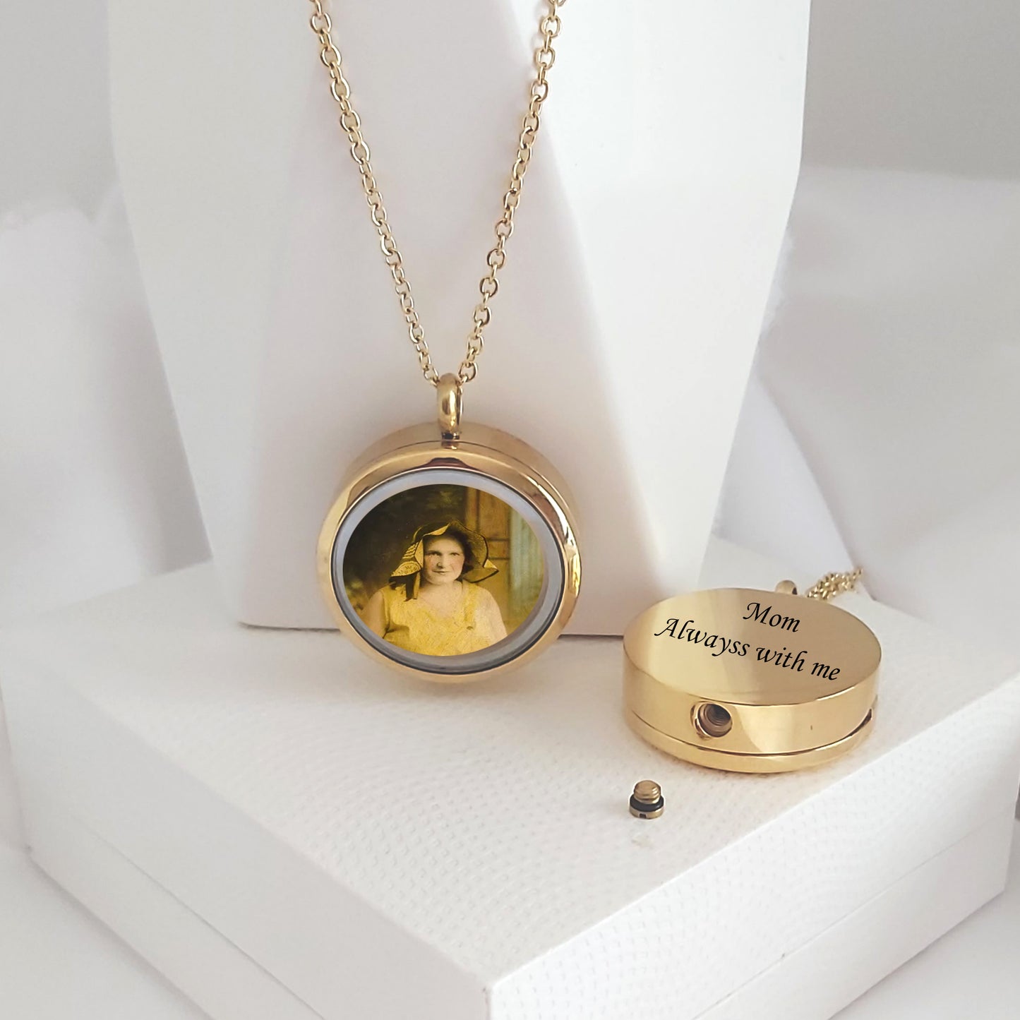Memorial locket with photos and urn for ashes.