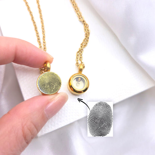 Memorial thumbprint urn necklace for human ashes.