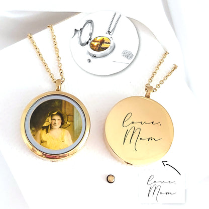 Two polished gold-tone round locket necklaces on a white background. One open locket displays a vintage portrait, while the closed locket is engraved with the handwritten words “Love, Mom.” A small circular inset shows a silver photo locket, chain, funnel, and tiny spoon used for filling the urn compartment.