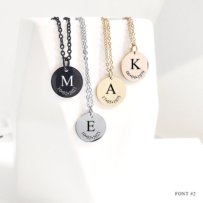 Four necklaces with engraved letters and dates on a white background