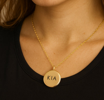 Locket engraved with initials and photos for her and him.