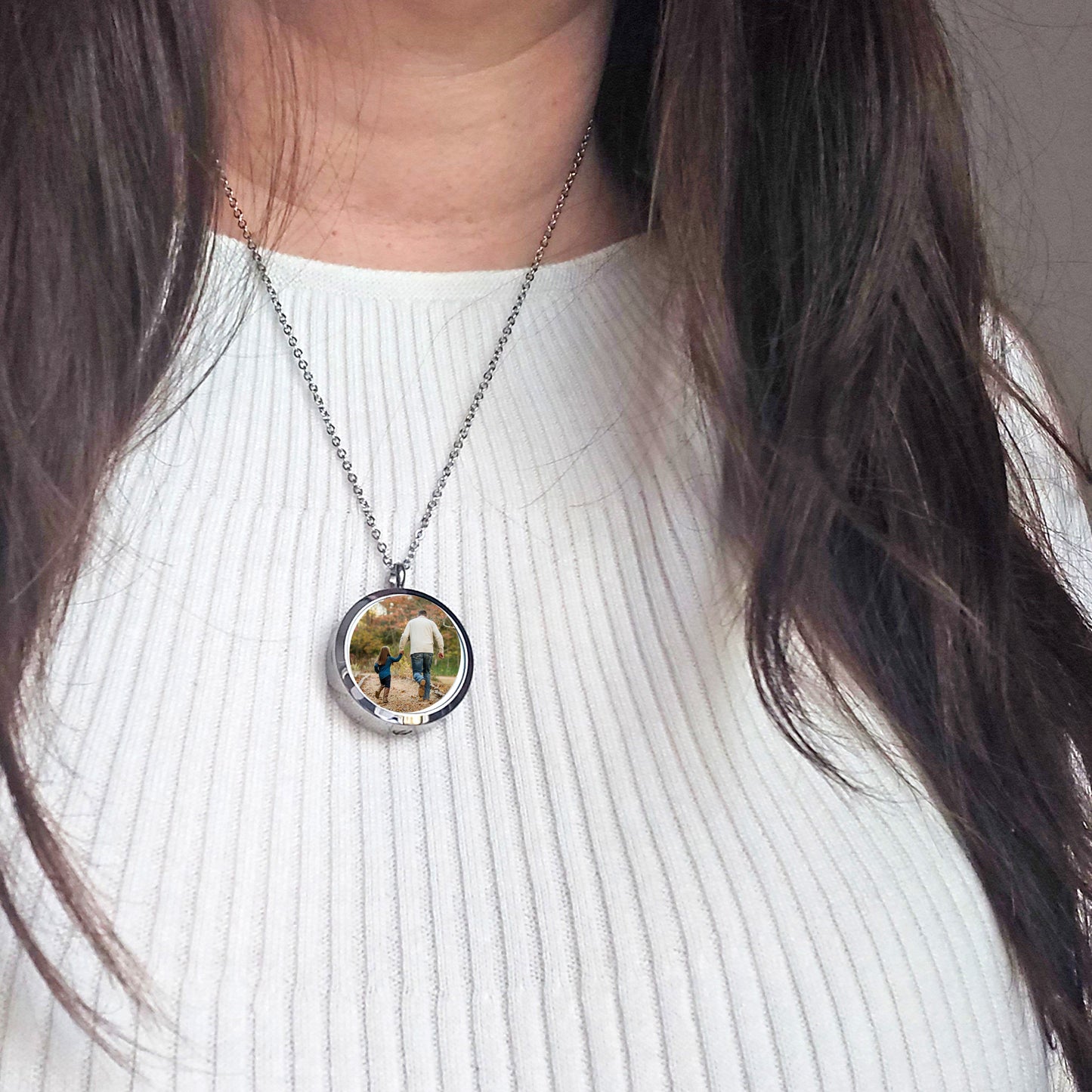 Memorial handwriting locket with photos and urn for ashes.