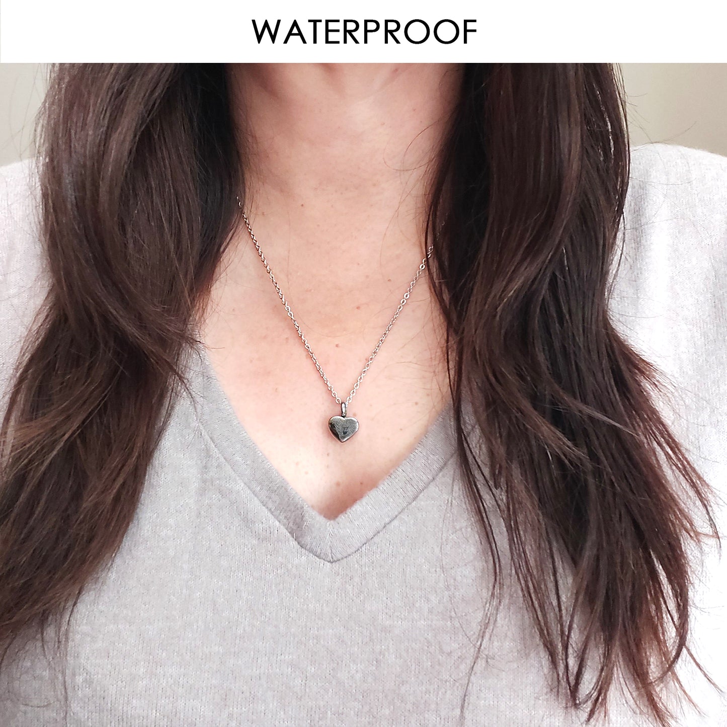 Personalized thumbprint heart urn necklace for human ashes.