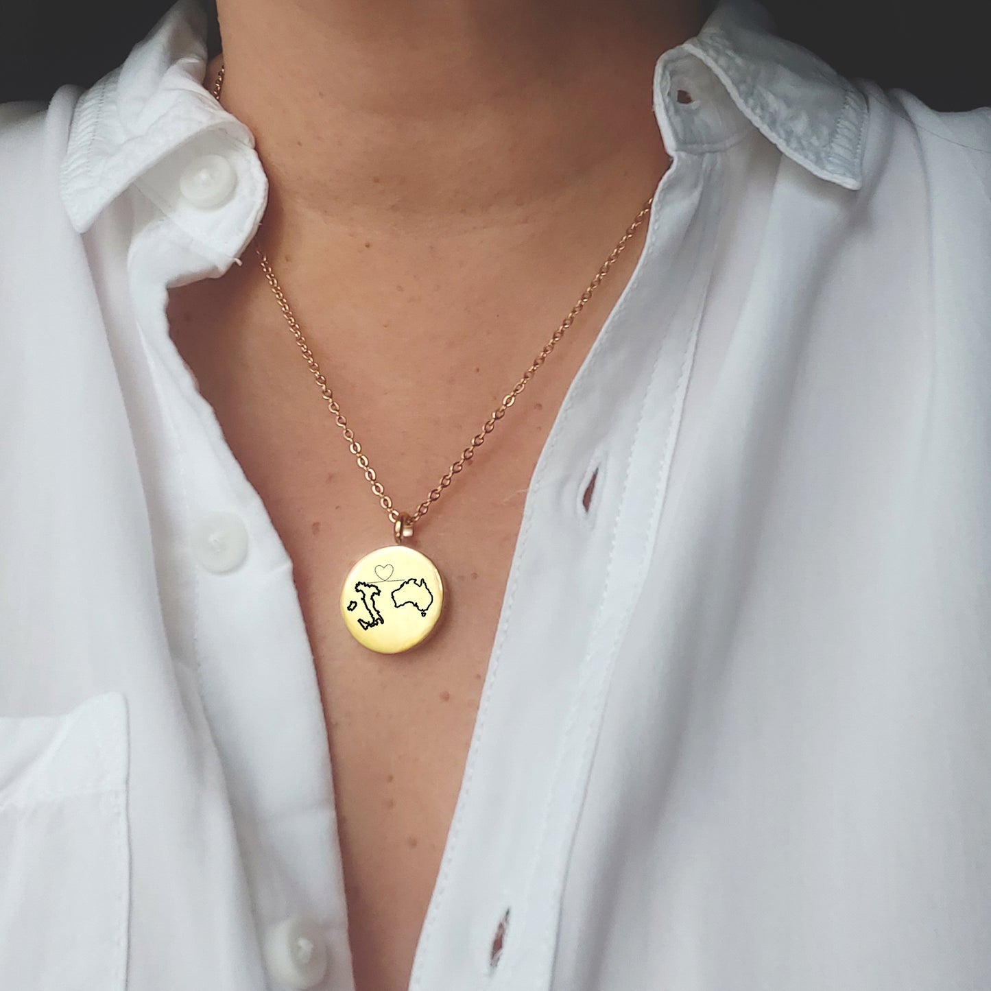 Two country map locket with photos.