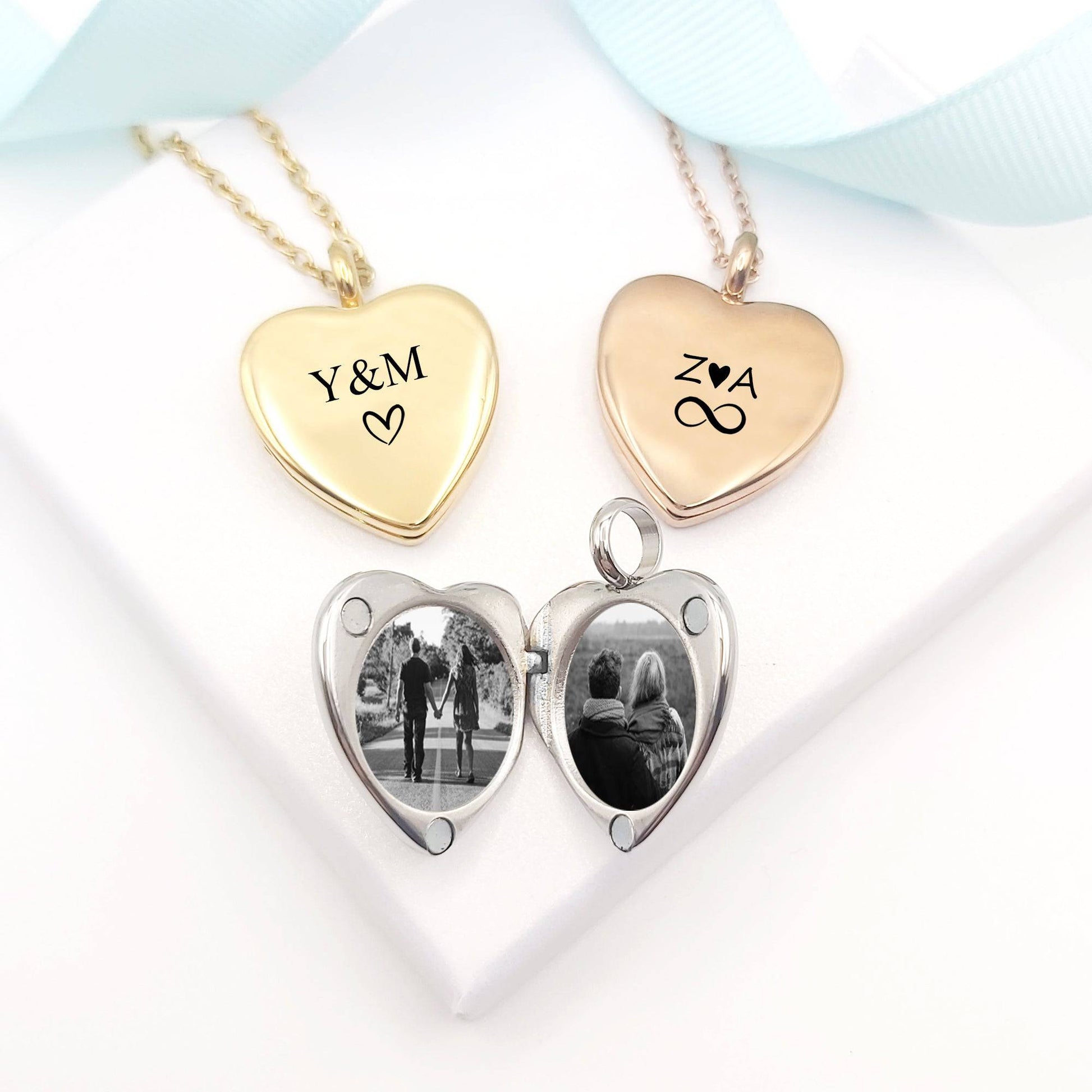 Heart-shaped photo locket with two heart pendants, one gold and one rose gold, on a white background.