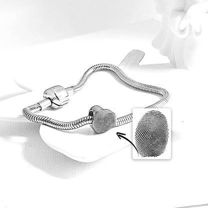 Engraved thumbprint heart charm for bracelet.