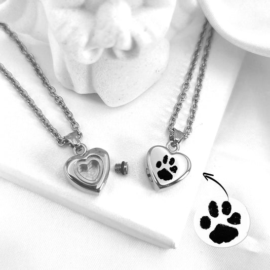 Actual paw print cremation heart urn necklace for ashes or hair.