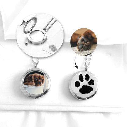 Pet paw print memorial locket with photos and urn for ashes.