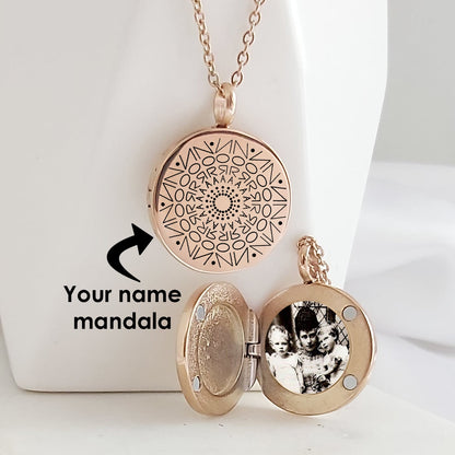 Rose-gold-tone round locket necklace displayed open and closed on a white stand. The closed locket features a black personalized name mandala engraving, while the open locket contains a circular black-and-white family photo.