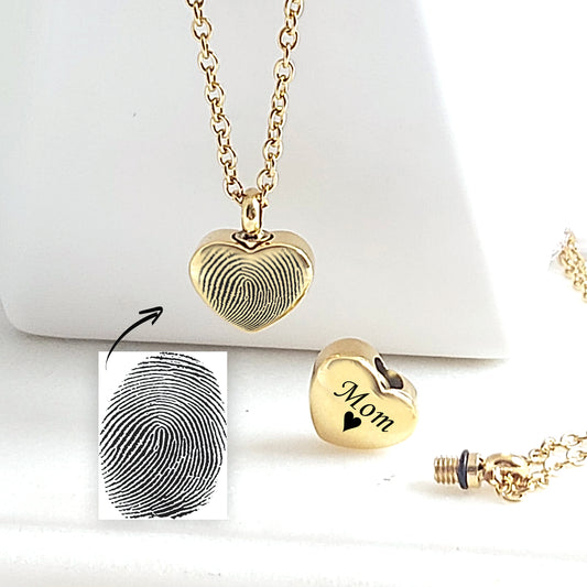 Personalized thumbprint heart urn necklace for human ashes.