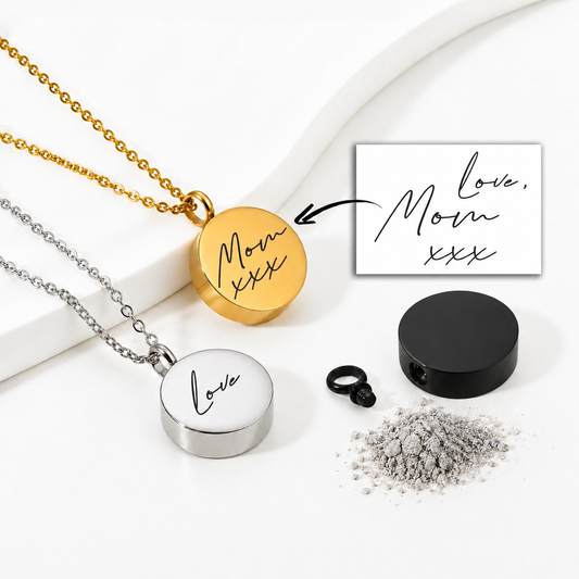 Round memorial urn necklaces displayed in gold, silver and black finishes on a white background. The gold pendant is engraved with “Mom xxx,” and the silver pendant reads “Love” in handwritten script. A handwritten “Love, Mom xxx” reference, black screw closure and symbolic ashes are also shown.