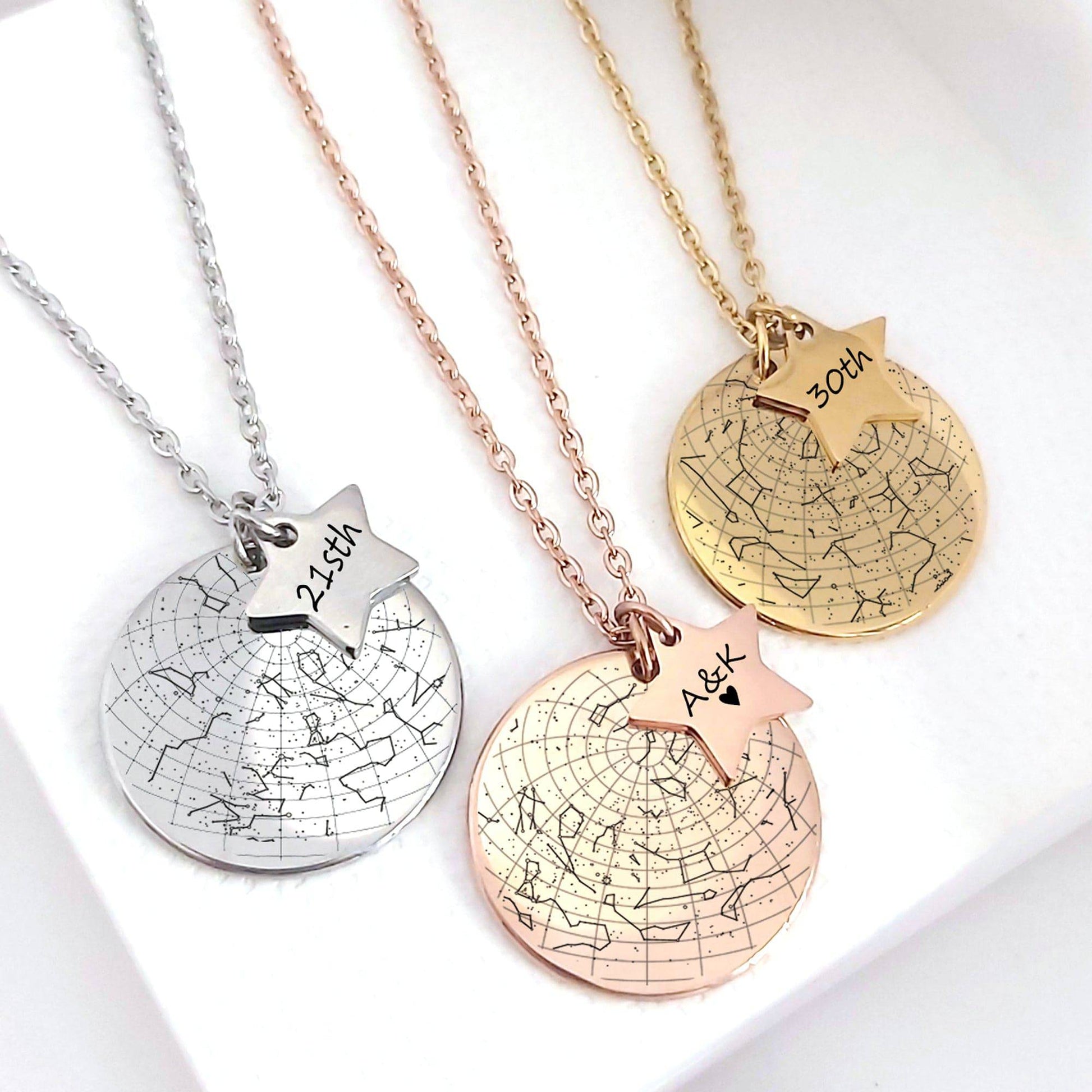 Three necklaces with star-shaped pendants and engraved text on a white background