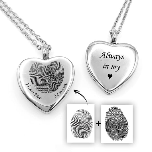 Close-up image of a silver heart locket engraved with two fingerprints forming a heart and personalized names, shown with front and back engraving options. Includes individual fingerprint samples and text engraving, representing a custom couples fingerprint necklace.